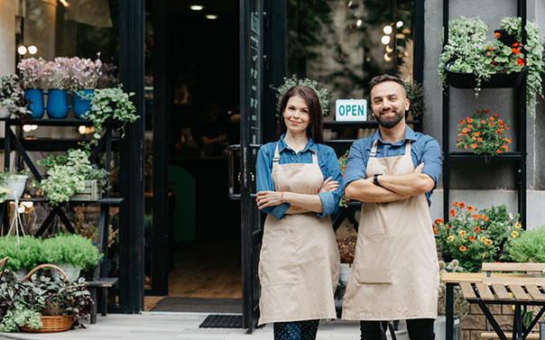 two flower shop owners standing in front of their small business